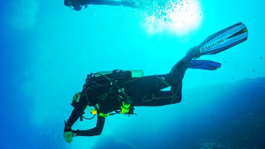 photography of two persons underwater