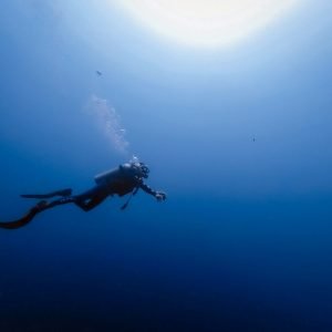 person swimming under water photography